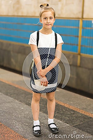 Little schoolgirl on the platform in the subway. vertical photo Stock Photo