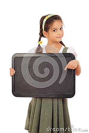 Little schoolgirl pointing to empty chalkboard Stock Photo