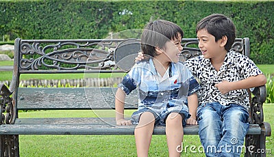 Little sibling boy laughing in the park Stock Photo