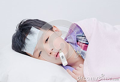 Little sick boy lying on bed Stock Photo