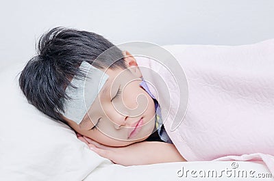 Little sick boy sleeping on bed Stock Photo