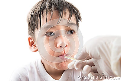 Little sick boy with temperature in mouth by doctor hand on white background Stock Photo