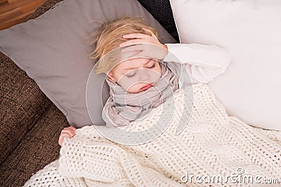 Little sick child lying on couch Stock Photo