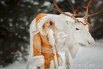 Portrait of beautiful Little girl in fur coat at winter forest Stock Photo