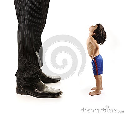 Little small child is looking at the giant legs Stock Photo