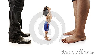 Little small child is looking at the giant legs Stock Photo
