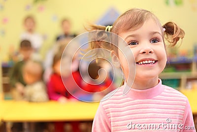 Little smiling girl in kindergarten Stock Photo