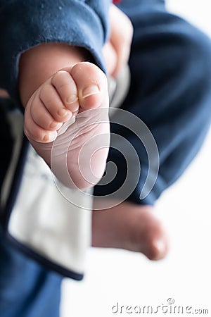 Little son foot, hold by his grandfather Stock Photo