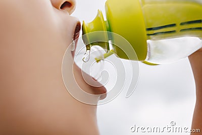 Little sports boy drinking water from filtering water bottle Stock Photo