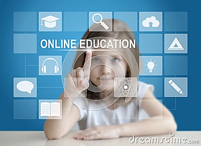 Little student girl choosing icon on virtual touch screen. Baby using a touch screen interface. Digital learning. E-learning Stock Photo