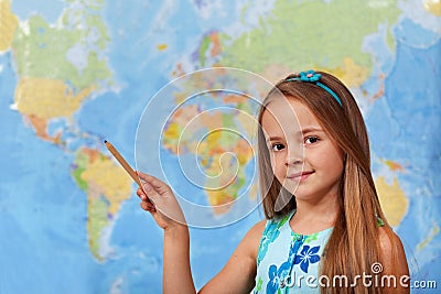 Little student girl pointing to blurry world map Stock Photo