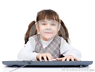 Little student girl typing keyboard. isolated on white background Stock Photo