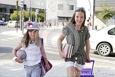 Little student girls going to school in city Stock Photo
