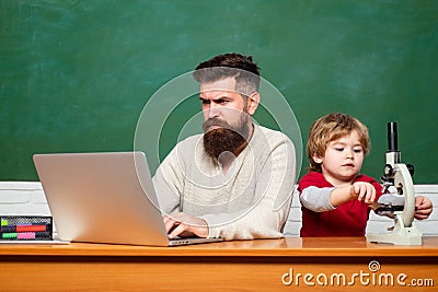 Little students. Daddy play with schoolboy. Elementary school. Parent Teacher. First day in school. Chalkboard ready for Stock Photo