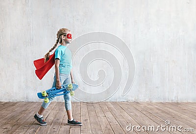 Little super girl with a skateboard Stock Photo