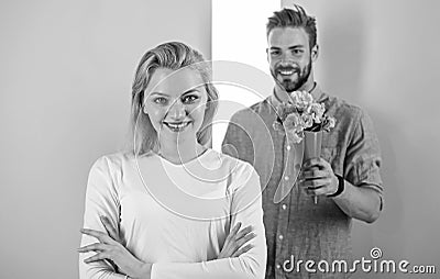 Little surprise for her. Boyfriend bring bouquet flowers to surprise her. Man ready for perfect date. Girl waiting for Stock Photo