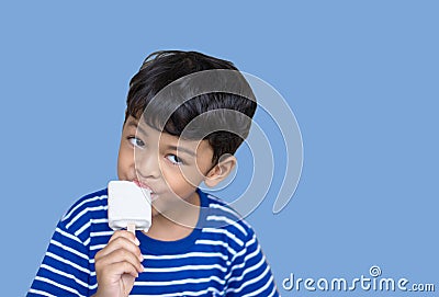 Little Thai boy eating white chocolate Ice cream Stock Photo