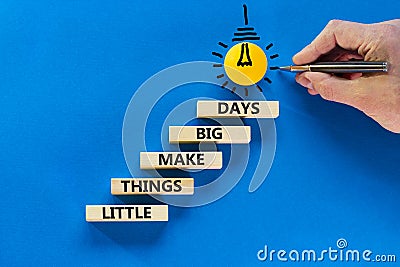 Little things make big days symbol. Wooden blocks with words Little things make big days. Light bulb icon. Businessman hand, pen. Stock Photo