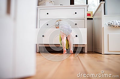 Toddler boy in a dangerous situation at home. Stock Photo