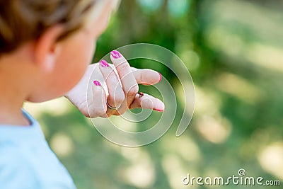 Little toddler child looking at a beautiful ladybug Stock Photo