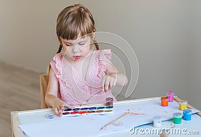 Little girl painting in her room Stock Photo