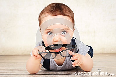 Little toddler holding glasses Stock Photo