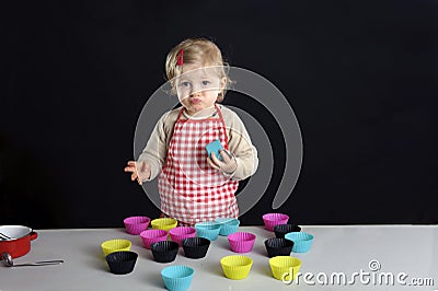 Little toddler making cupcakes, Stock Photo