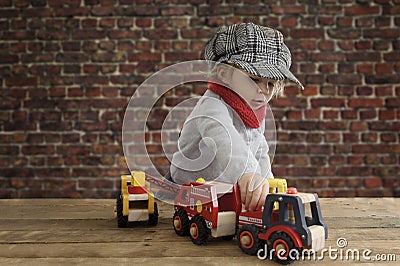Little toddler playing with wooden cars Stock Photo