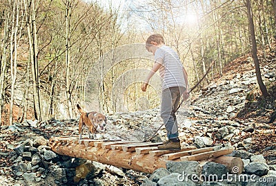 Little traveler in spring forest with his dog Stock Photo