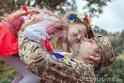 Little Ukrainian girl meets dad from the war Stock Photo