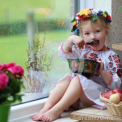 Little ukrainian girl in national dress with traditional food Stock Photo