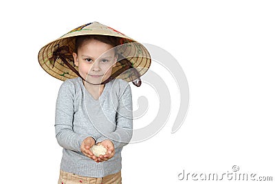 Little Vietnamese girl holds in her hands rice isolated on white Stock Photo