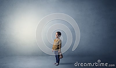 Little waggish kid in an empty room Stock Photo