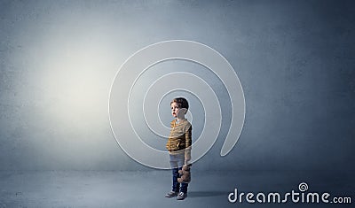 Little waggish kid in an empty room Stock Photo