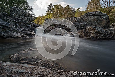 Little waterfall in front of trees Stock Photo