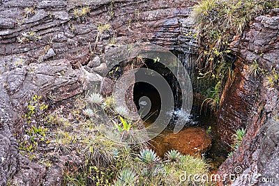 Little waterfall in sinkhole inside rock at mount Roraima Stock Photo