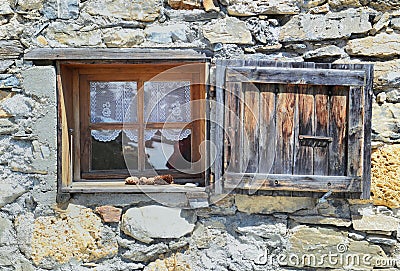 Little window and shutter on a stoned facade Stock Photo