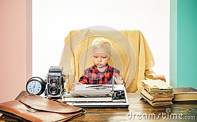 Little writer work on book at desk. Boy writer type on vintage typewriter in office Stock Photo