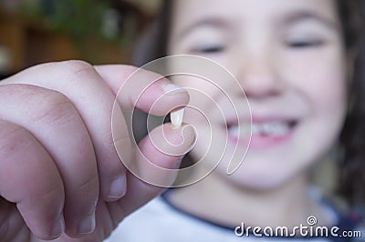 Little 5 years old girl showing her first baby tooth fallen out Stock Photo