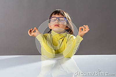 Zen little yoga child breathing, practicing yoga and closing eyes Stock Photo