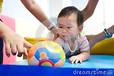 Little young kid learning in play and learn class with her mother. Stock Photo