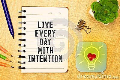 Live every day with intention. Words written under torn paper. Motivation concept text Stock Photo