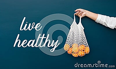 Live healthy concepts with female holding fresh orange from garden Stock Photo