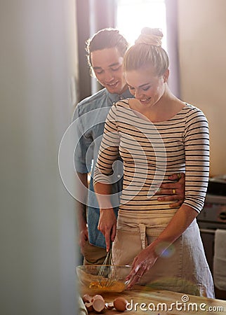 Live life and love baking. a young couple bonding in the kitchen. Stock Photo