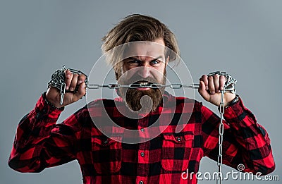 Live life. man in captivity. concept applicable for business. man tearing heavy steel chain by teeth. conceptual symbol Stock Photo