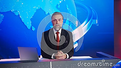 Live News Studio with Professional Male Newscaster Reporting on the Events of the Day. Broadcastin Stock Photo
