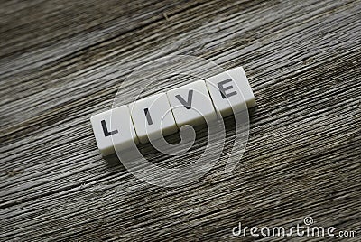 Live word made of square letter word on wooden background Stock Photo
