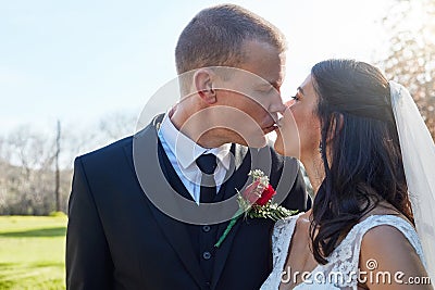 And so they lived happily every after. a bride and groom kissing on their wedding day. Stock Photo