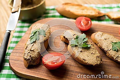 Liver pate on the bread on wooden tray. Stock Photo