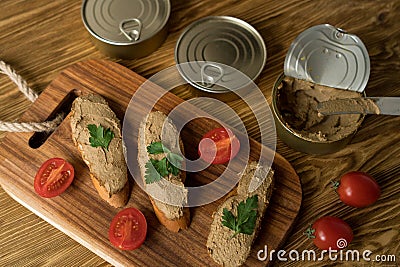 Liver pate on the bread on wooden tray. Stock Photo